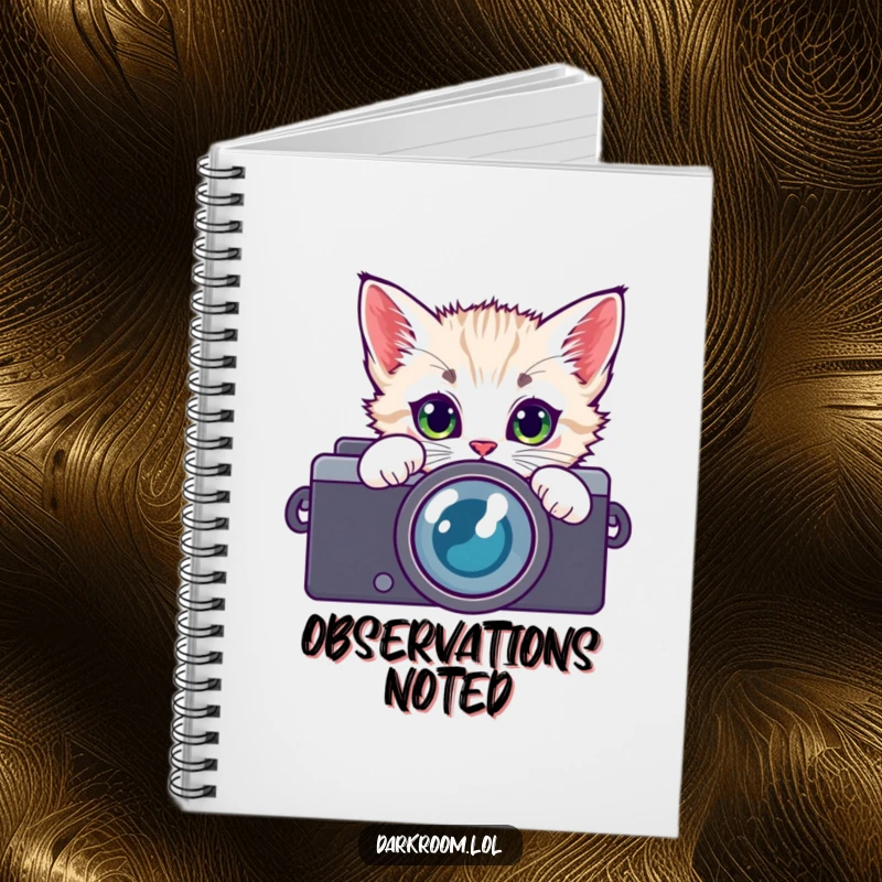 Funny kitten camera lens notebook, peeking with wide, curious eyes, ideal for jotting down photography notes and feline-inspired thoughts.
